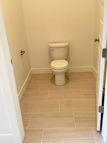 Bathroom featuring baseboards and toilet