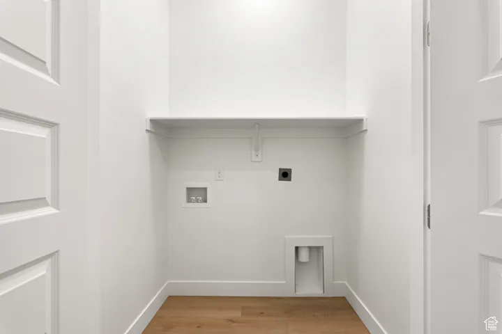 Laundry room featuring electric dryer hookup, washer hookup, and light wood finished floors