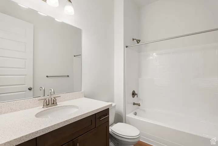 Bathroom with vanity and shower / washtub combination