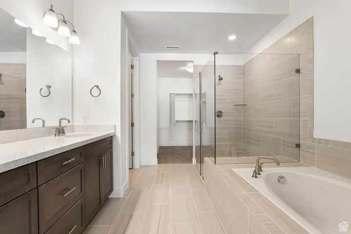 Bathroom with vanity, a stall shower, a bath, and tile patterned floors