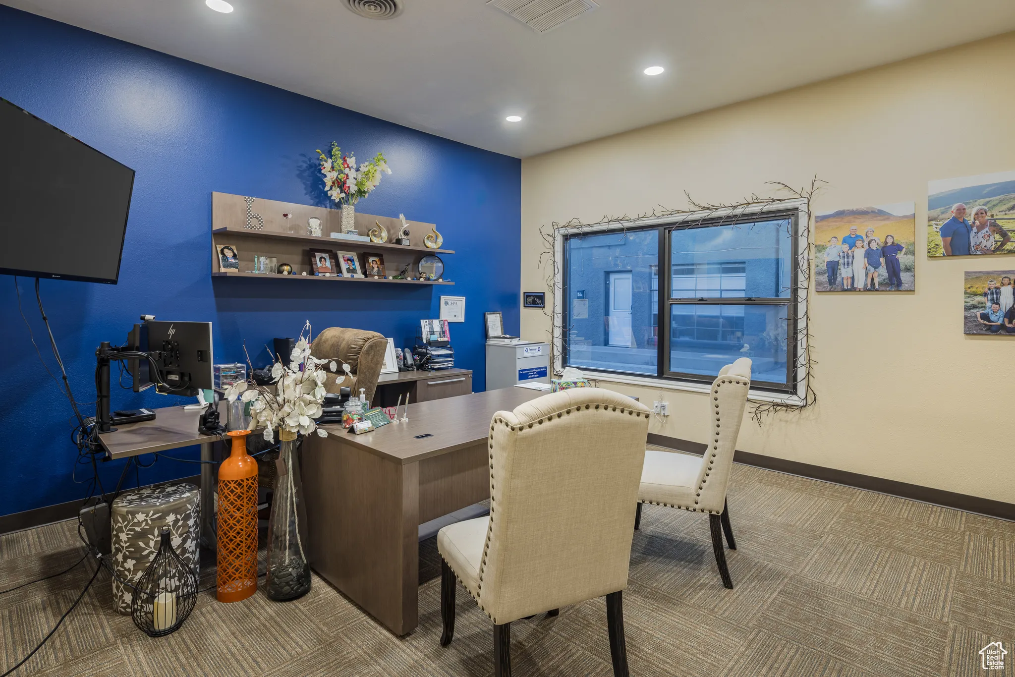 Carpeted office space with recessed lighting, visible vents, and baseboards