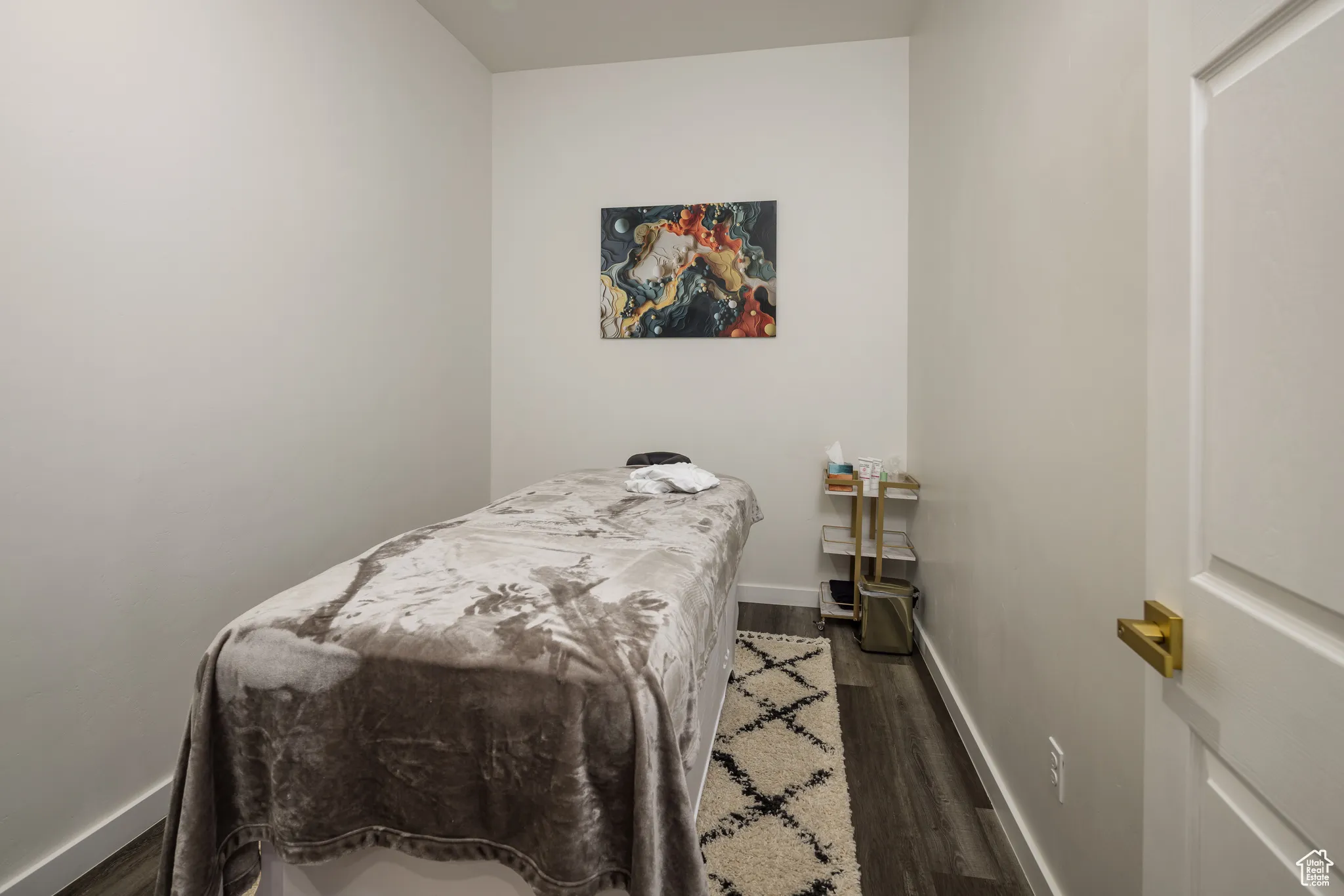 Bedroom with baseboards and wood finished floors