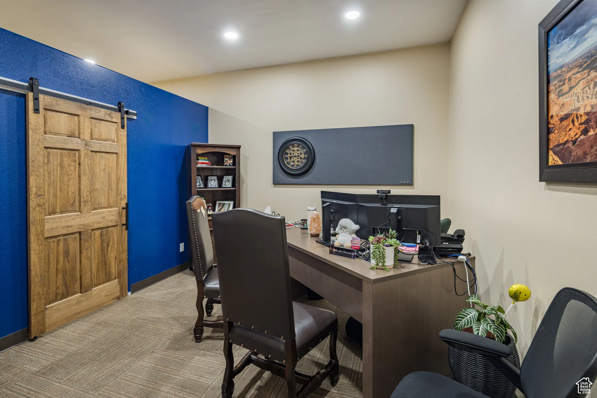 Carpeted office space with a barn door, baseboards, and recessed lighting