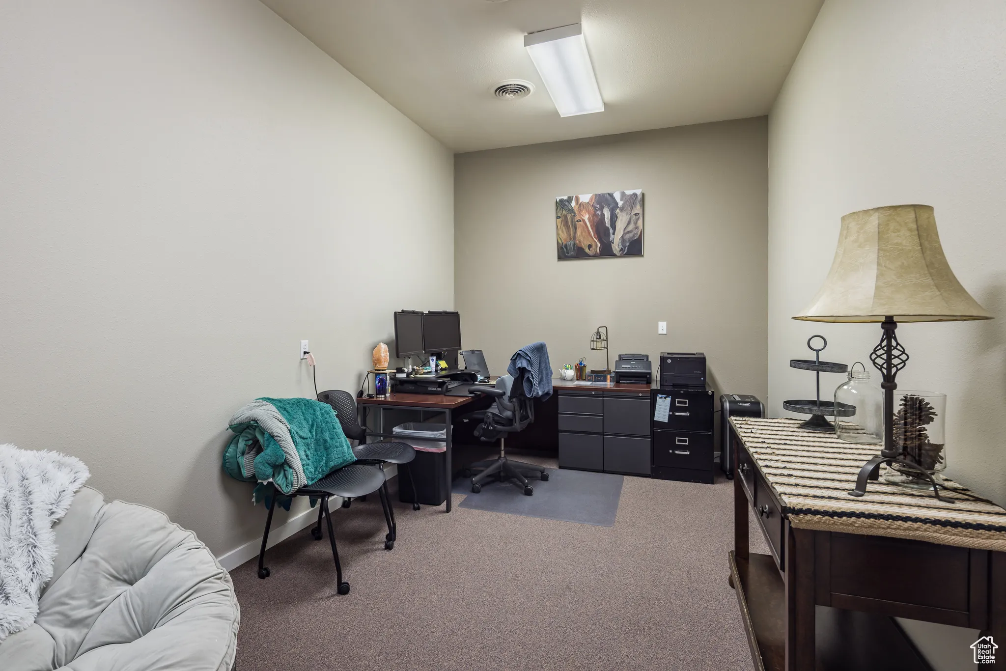 Carpeted office with visible vents