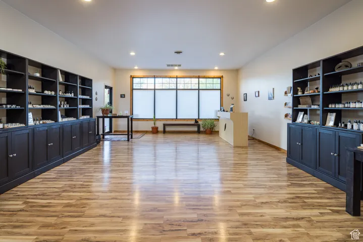 Interior space featuring baseboards, recessed lighting, visible vents, and light wood-type flooring