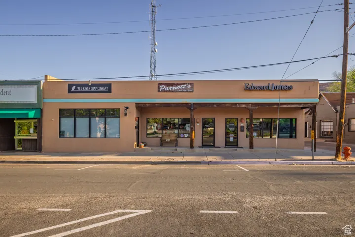 View of building exterior with uncovered parking