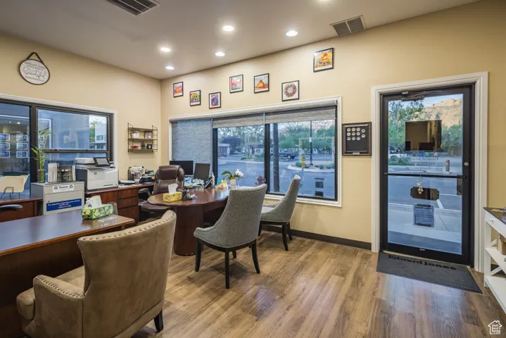 Office area featuring visible vents, baseboards, wood finished floors, and recessed lighting