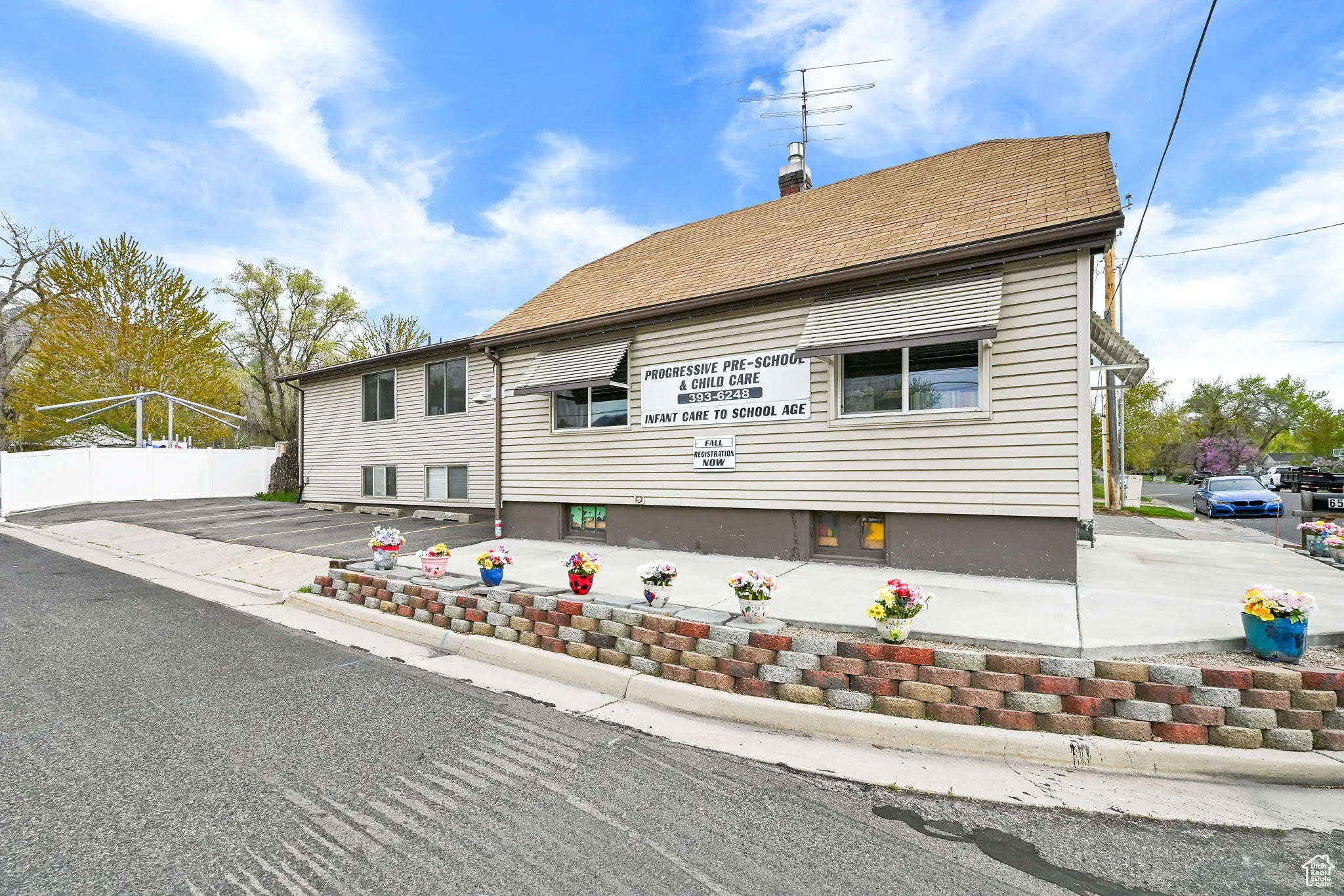 View of front of property featuring fence and a chimney