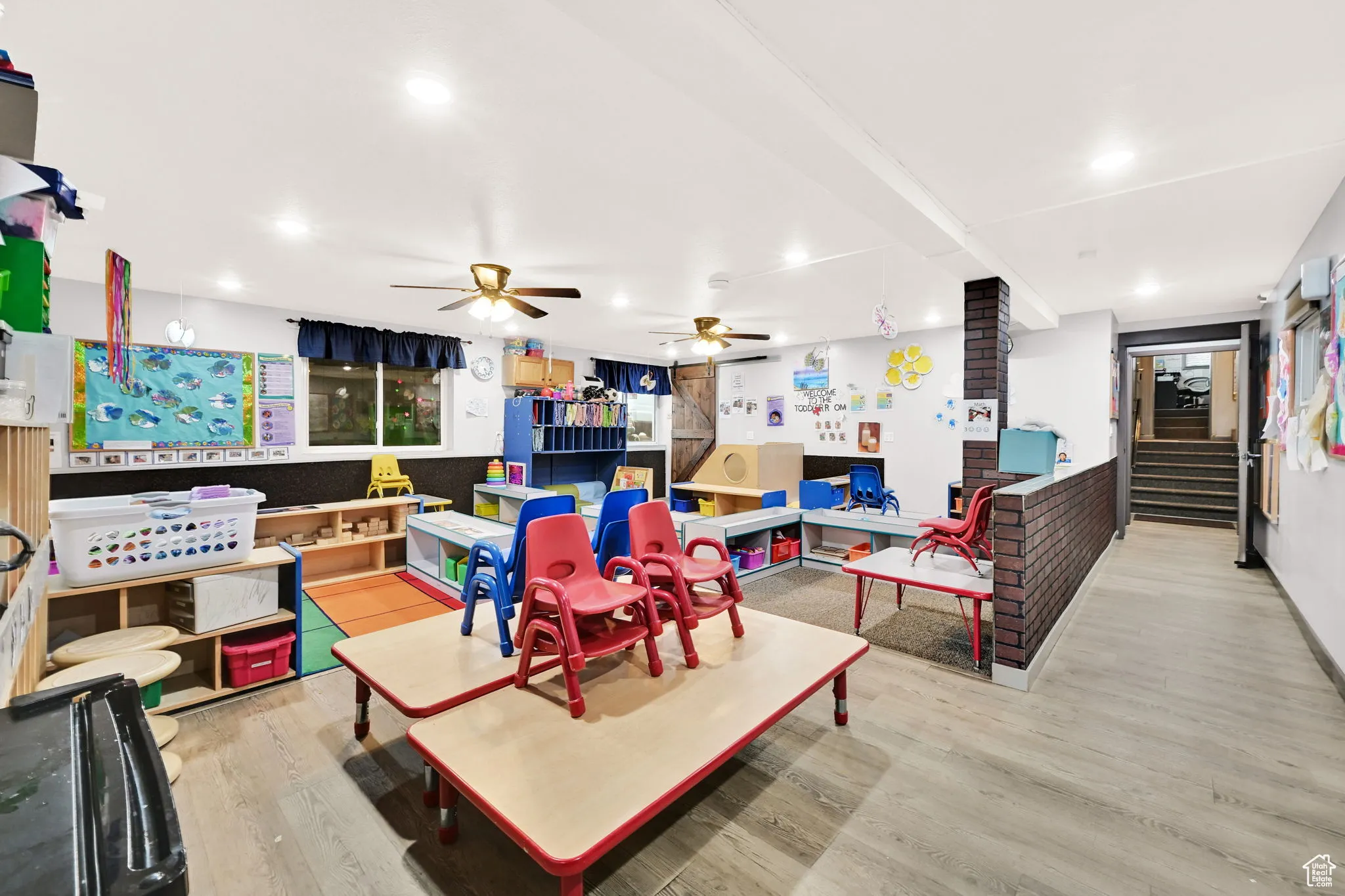 Living room with recessed lighting, stairs, ceiling fan, and wood finished floors