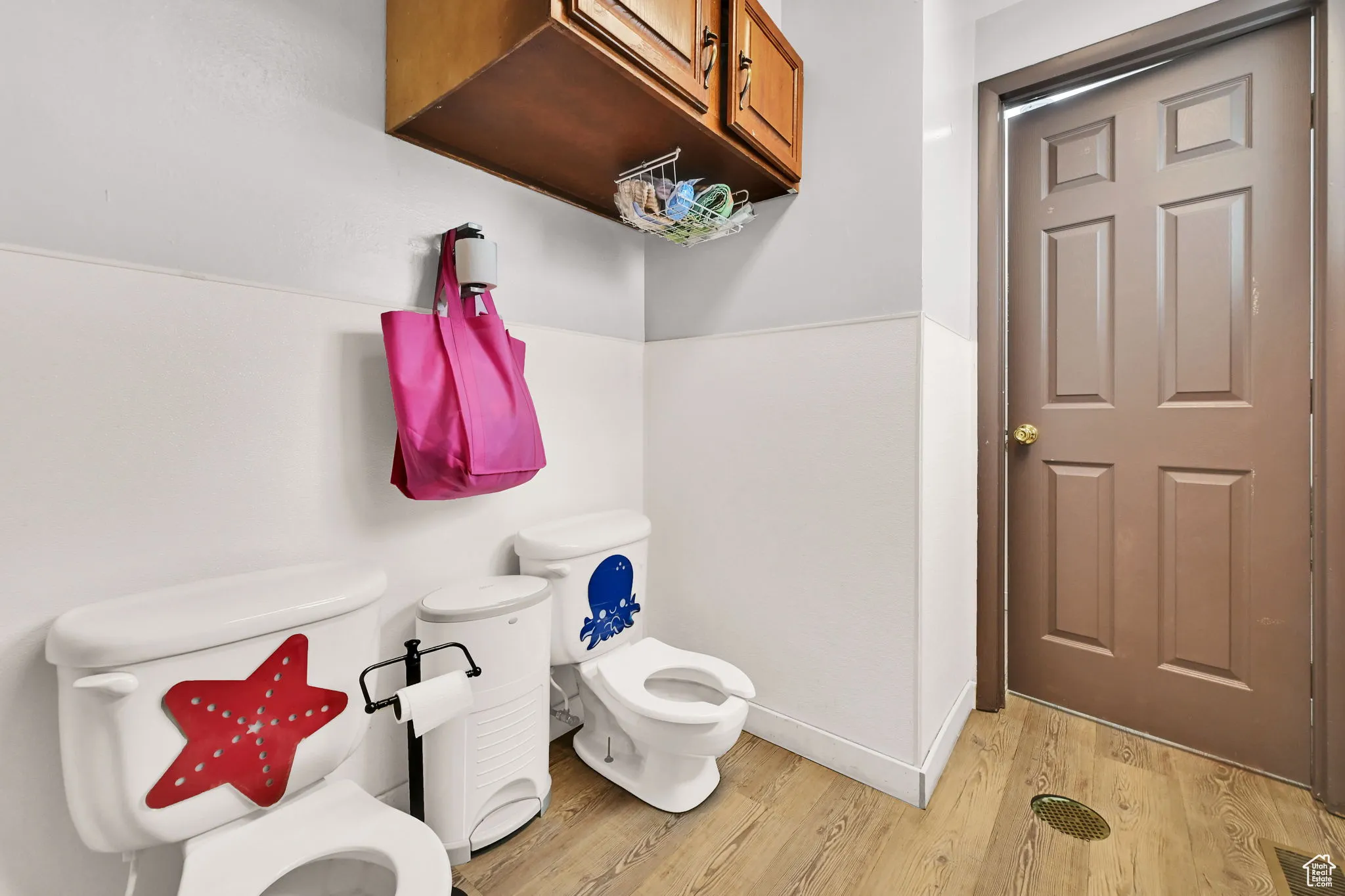 Bathroom featuring visible vents, wood finished floors, and toilet