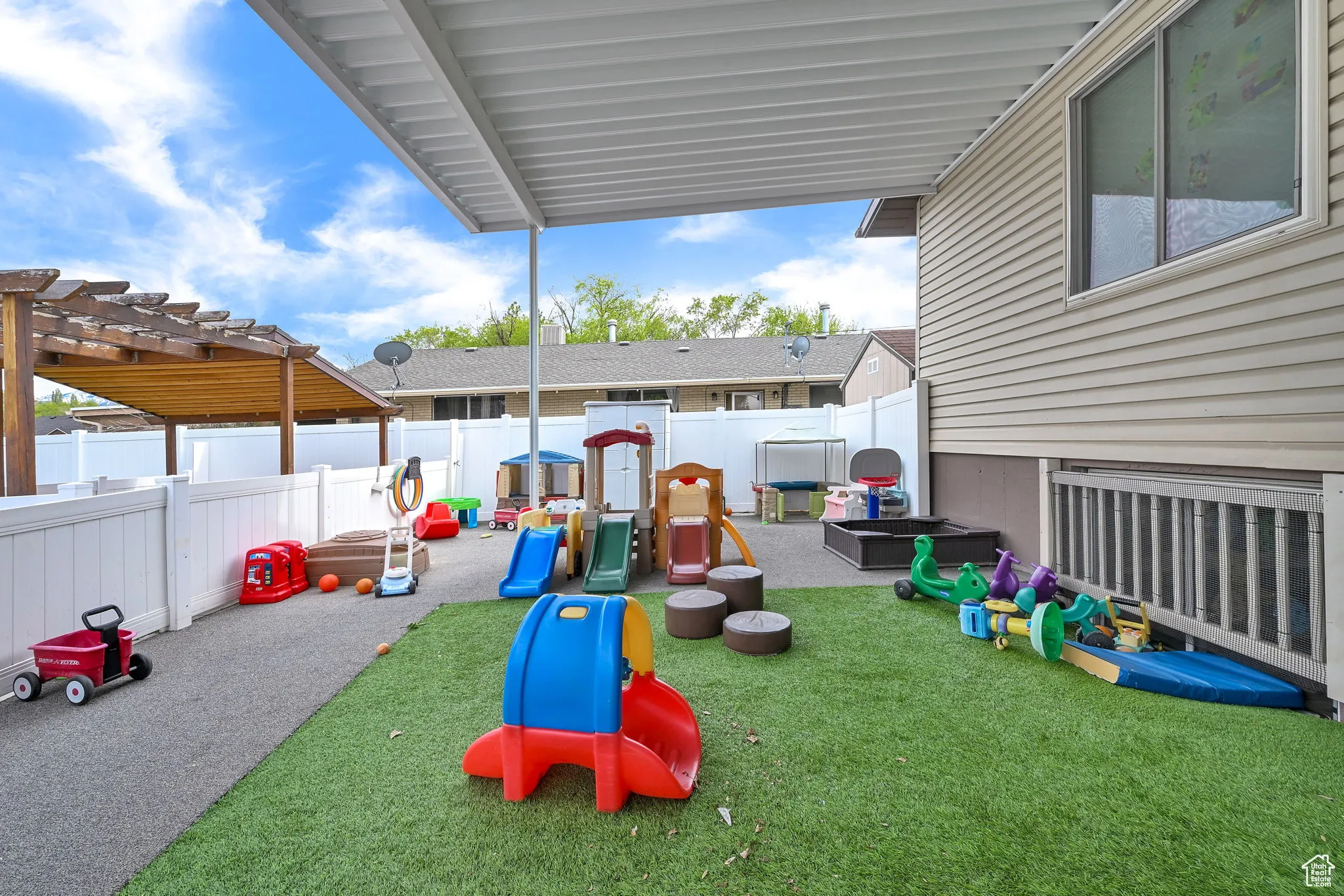 View of playground with a fenced backyard, a yard, and a pergola