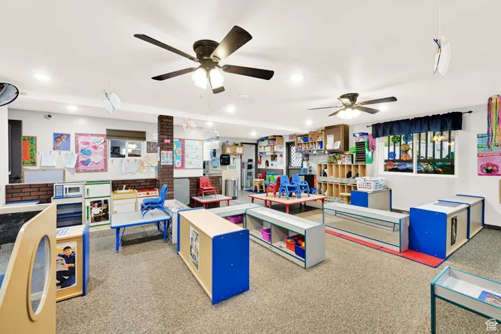 Recreation room featuring a ceiling fan and recessed lighting