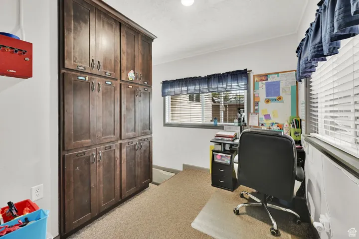 Home office featuring light colored carpet