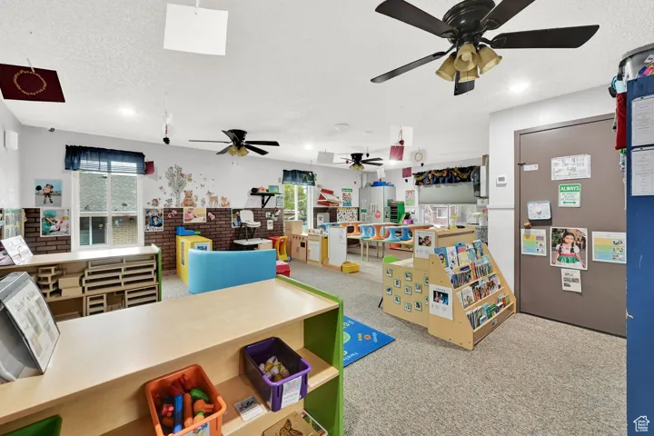 Rec room with a textured ceiling, a ceiling fan, recessed lighting, and carpet floors