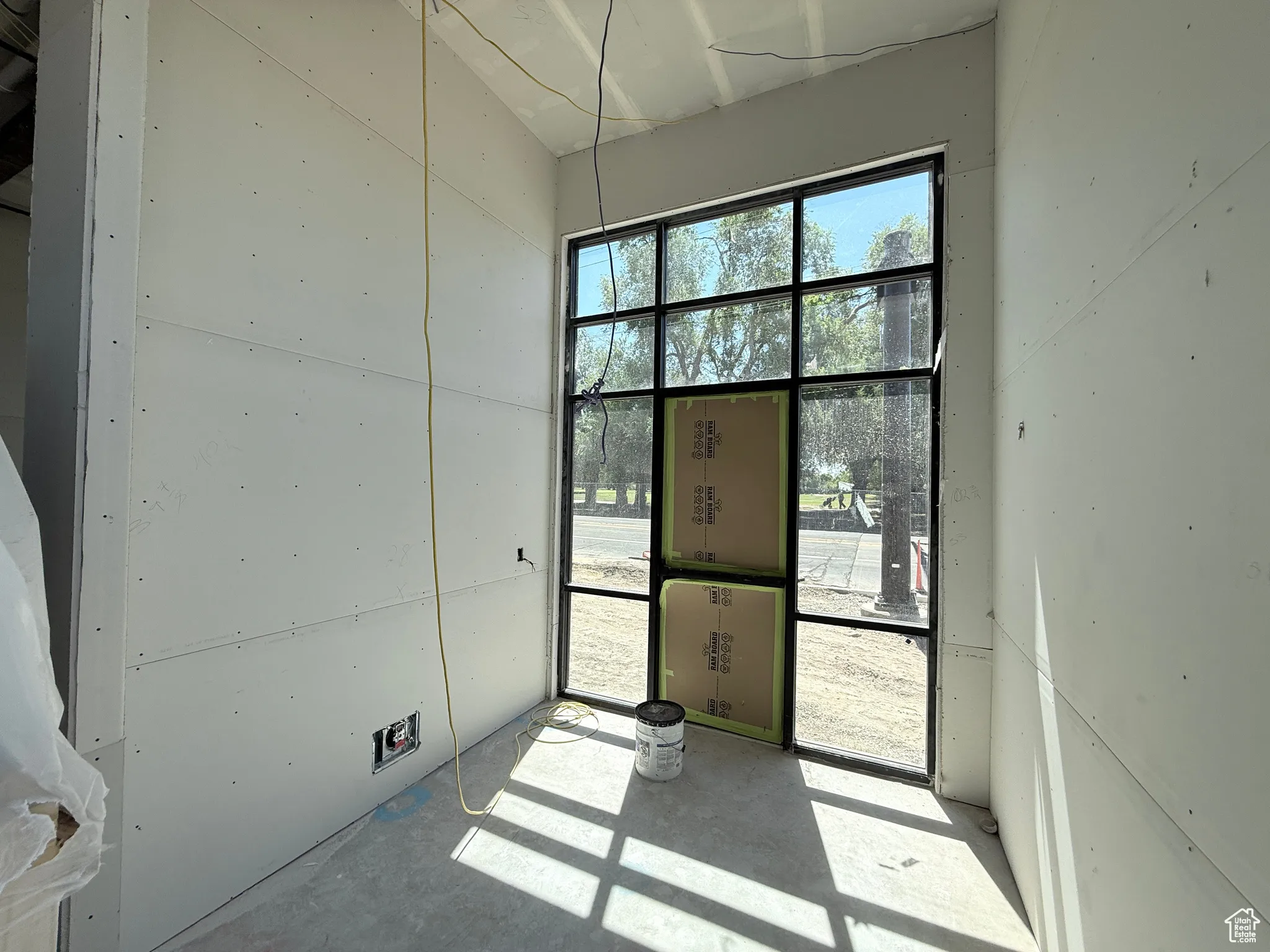 Unfurnished room featuring unfinished concrete floors