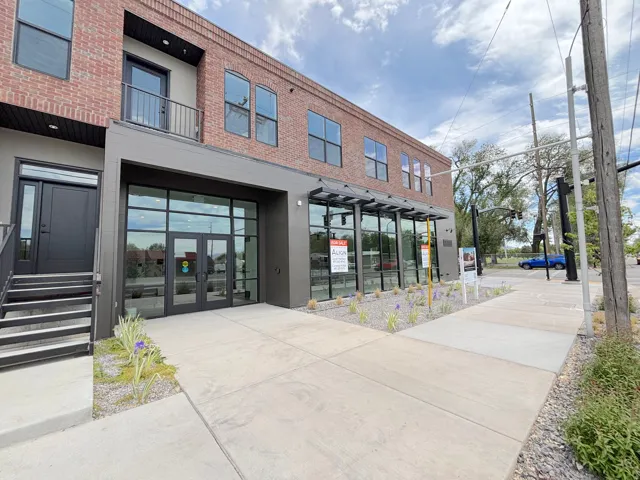 Contemporary brick and siding facade with large pane windows