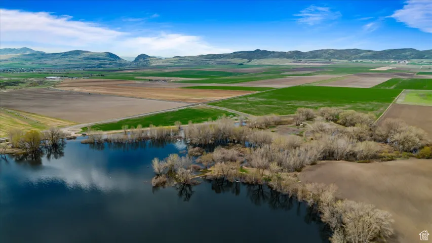 Birds eye view of property featuring a water and mountain view