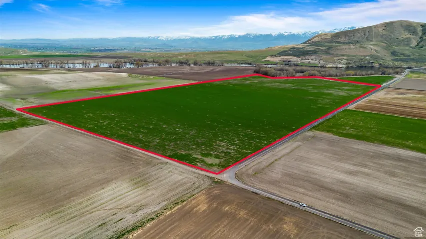 Birds eye view of property with a water and mountain view