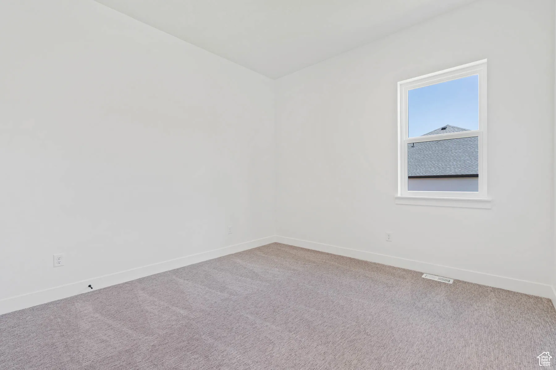 Empty room featuring baseboards, carpet flooring, and visible vents