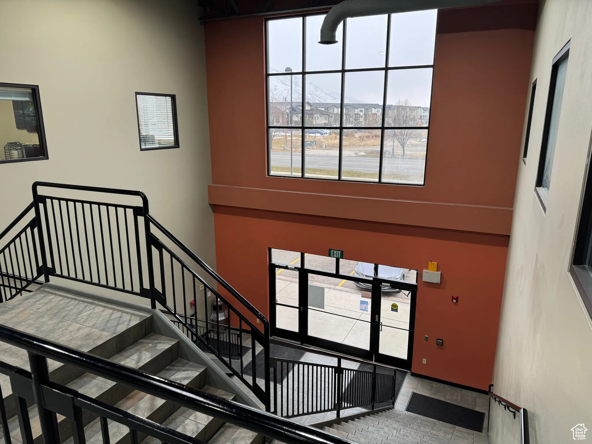 Staircase with a high ceiling and a wealth of natural light