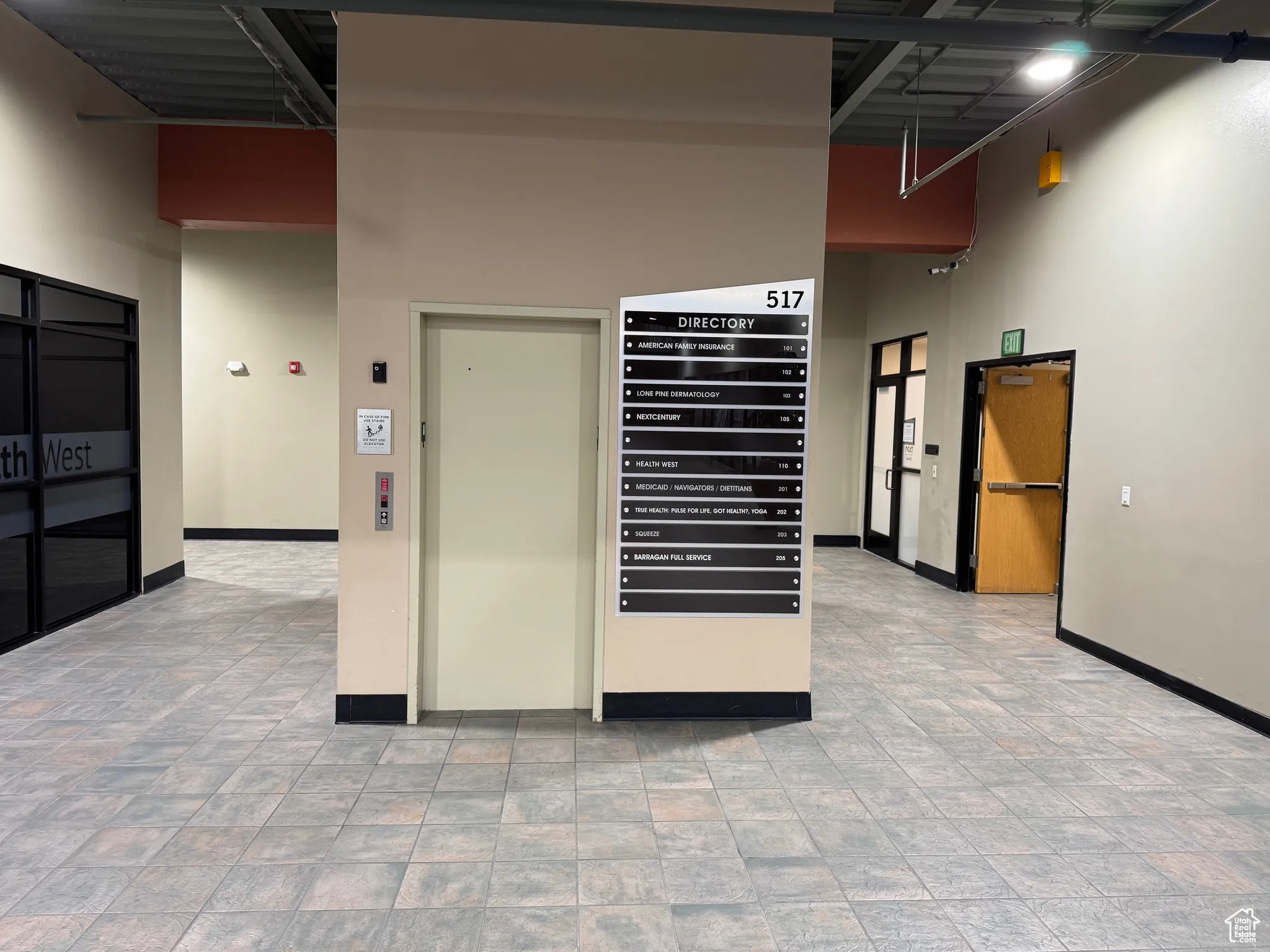 Interior space featuring baseboards and a high ceiling