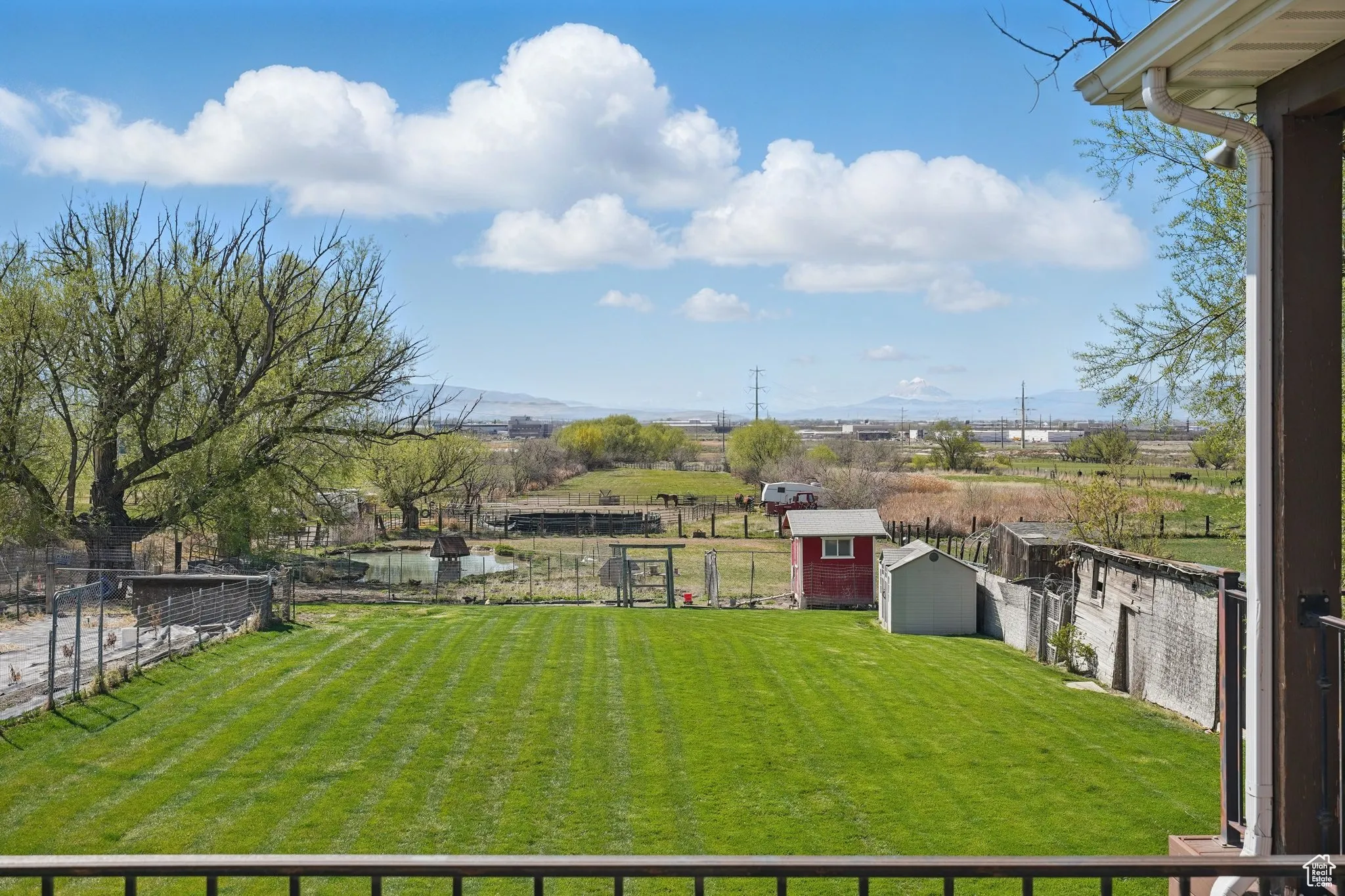 View of yard featuring a fenced backyard, an outdoor structure, and a storage shed