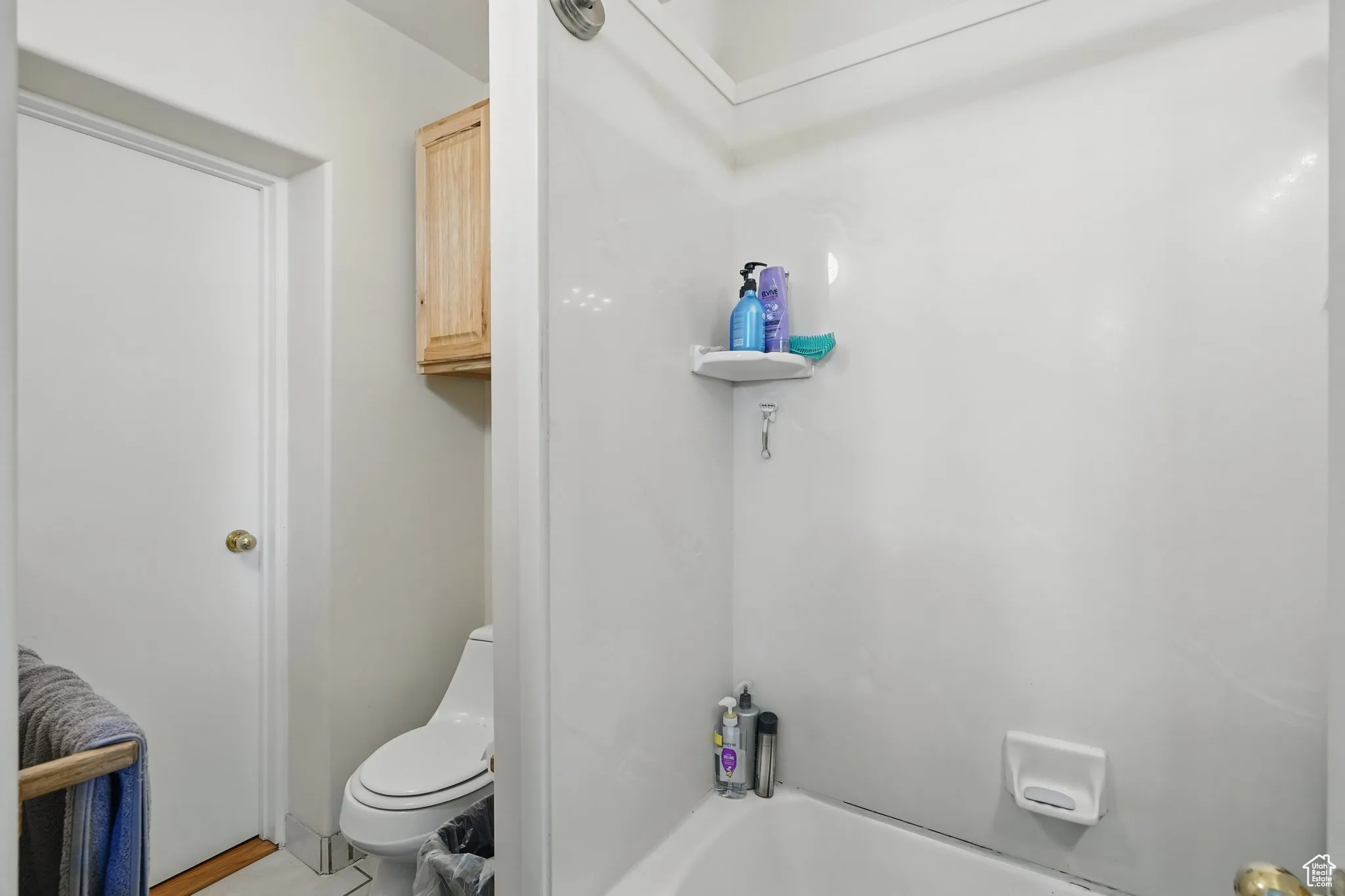 Full bathroom featuring bathtub / shower combination and toilet