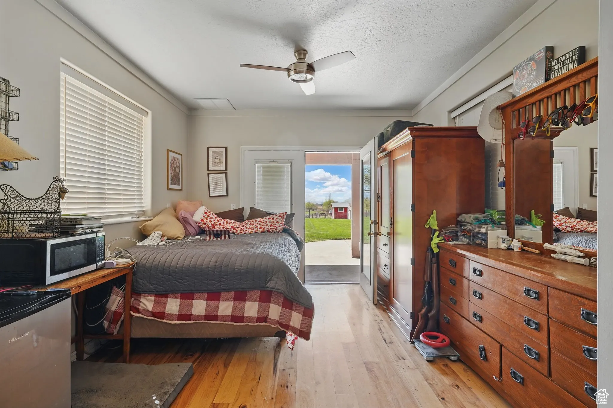 Bedroom with crown molding, ceiling fan, wood-type flooring, and access to exterior