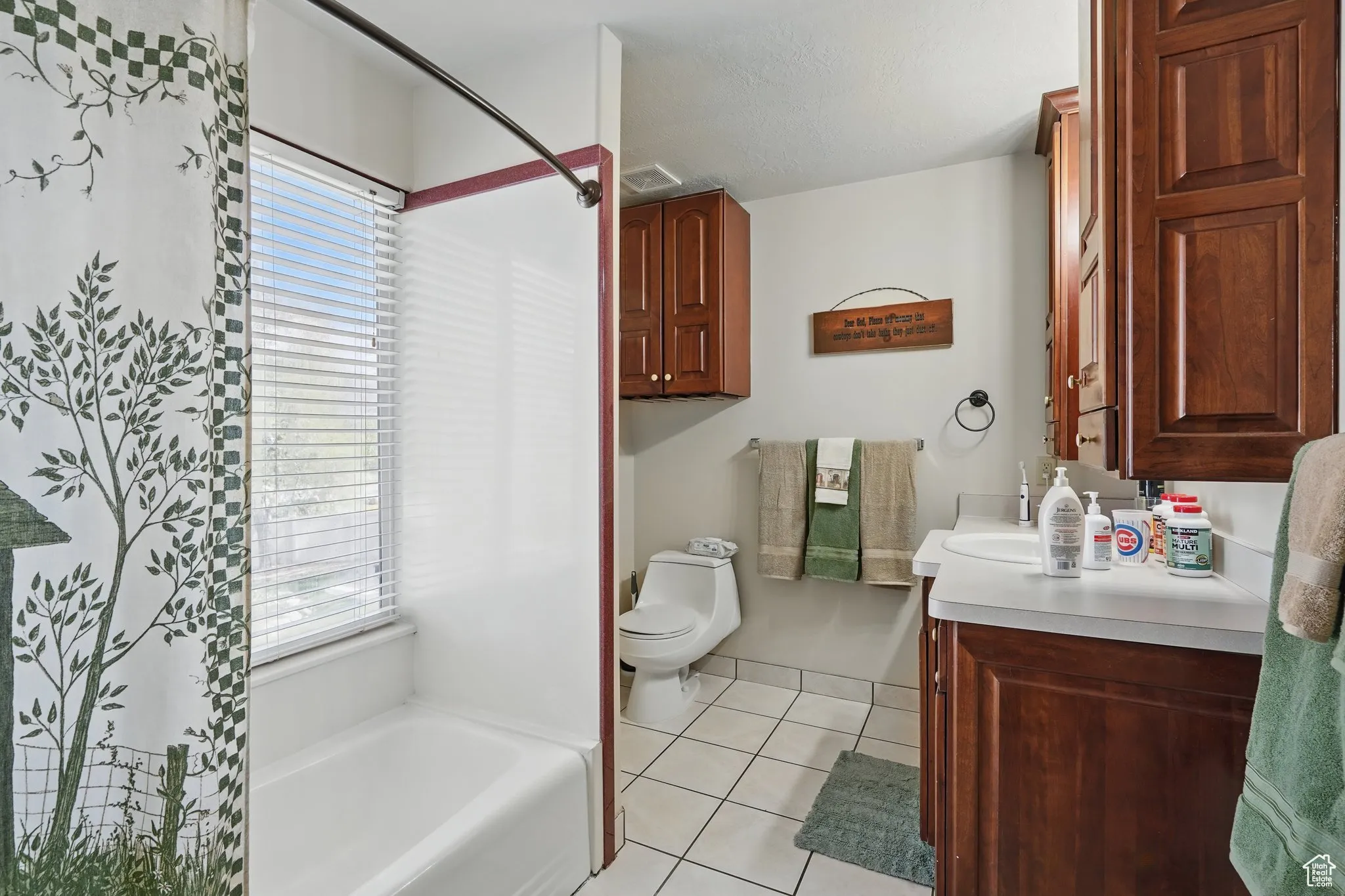 Full bathroom featuring vanity, toilet, a bathtub, tile patterned floors, and a shower with curtain