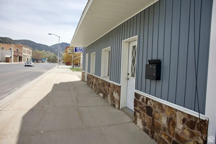 View of home's exterior featuring a mountain view, board and batten siding, and stone siding