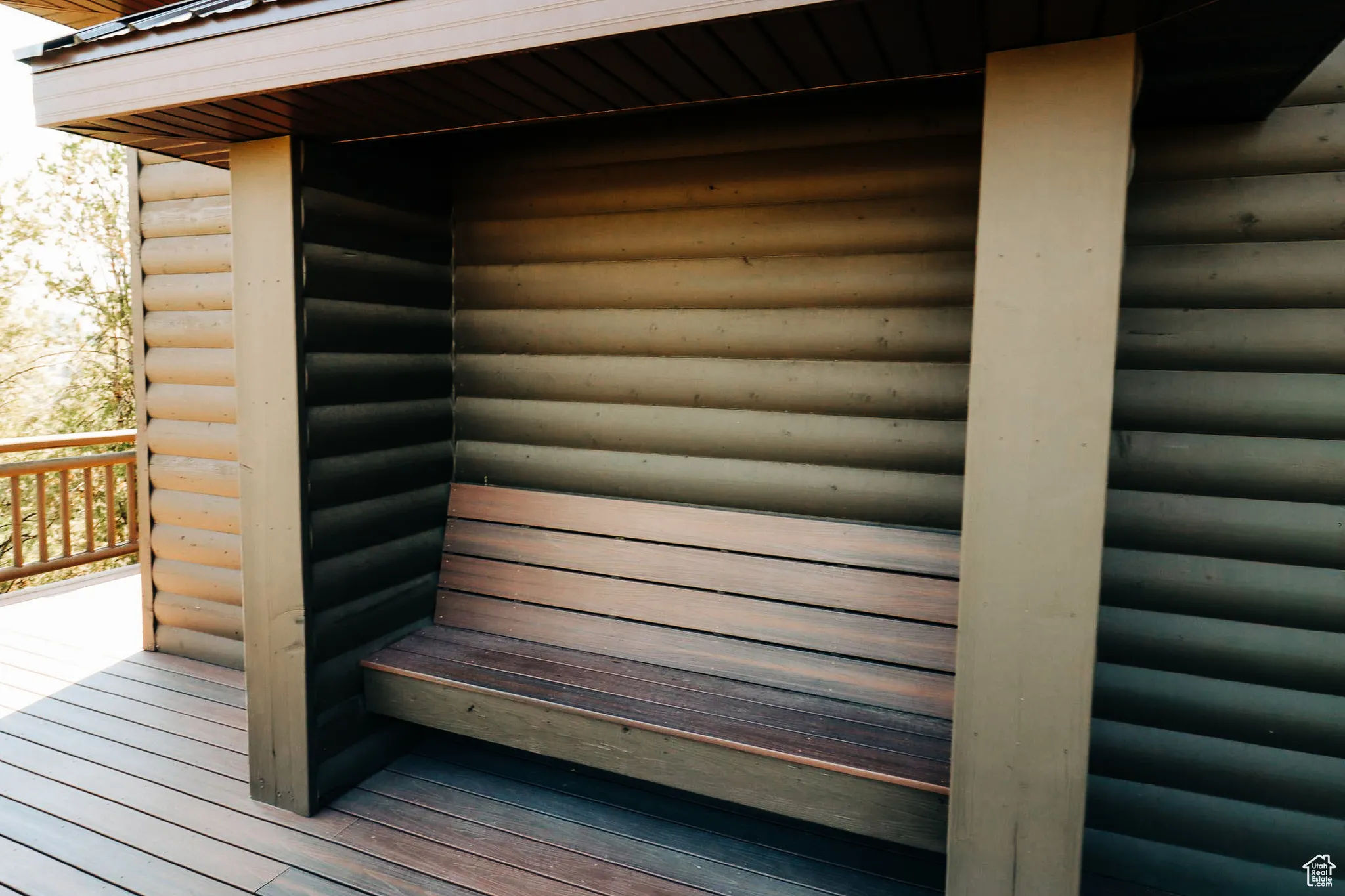 Exterior view of a sauna / steam room and faux log siding
