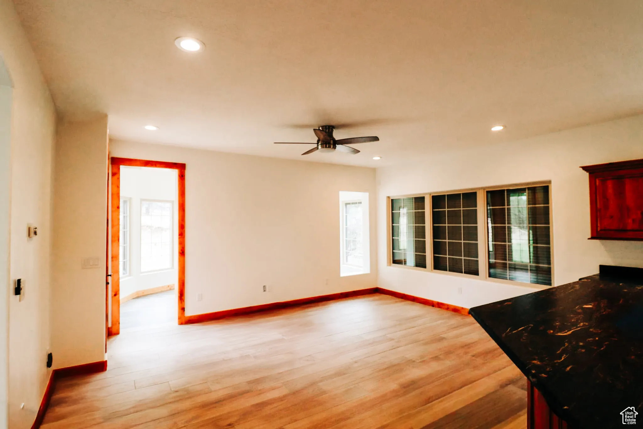 Unfurnished living room featuring light wood-type flooring, recessed lighting, and a ceiling fan