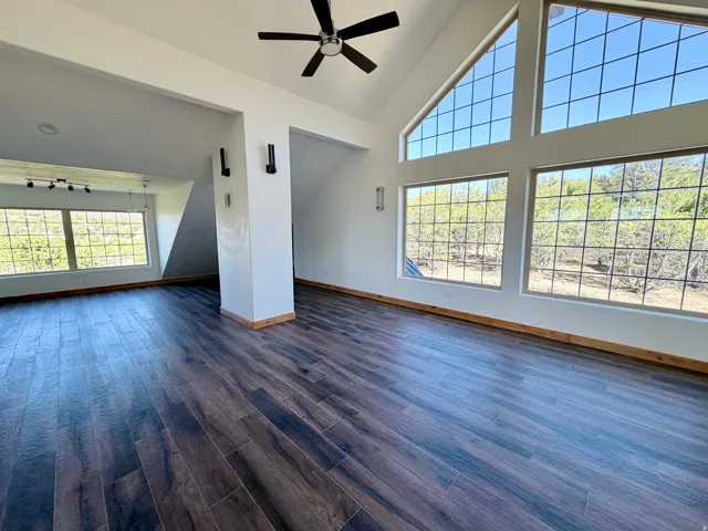 Spacious interior featuring vaulted ceilings and extensive window lines with grid patterns