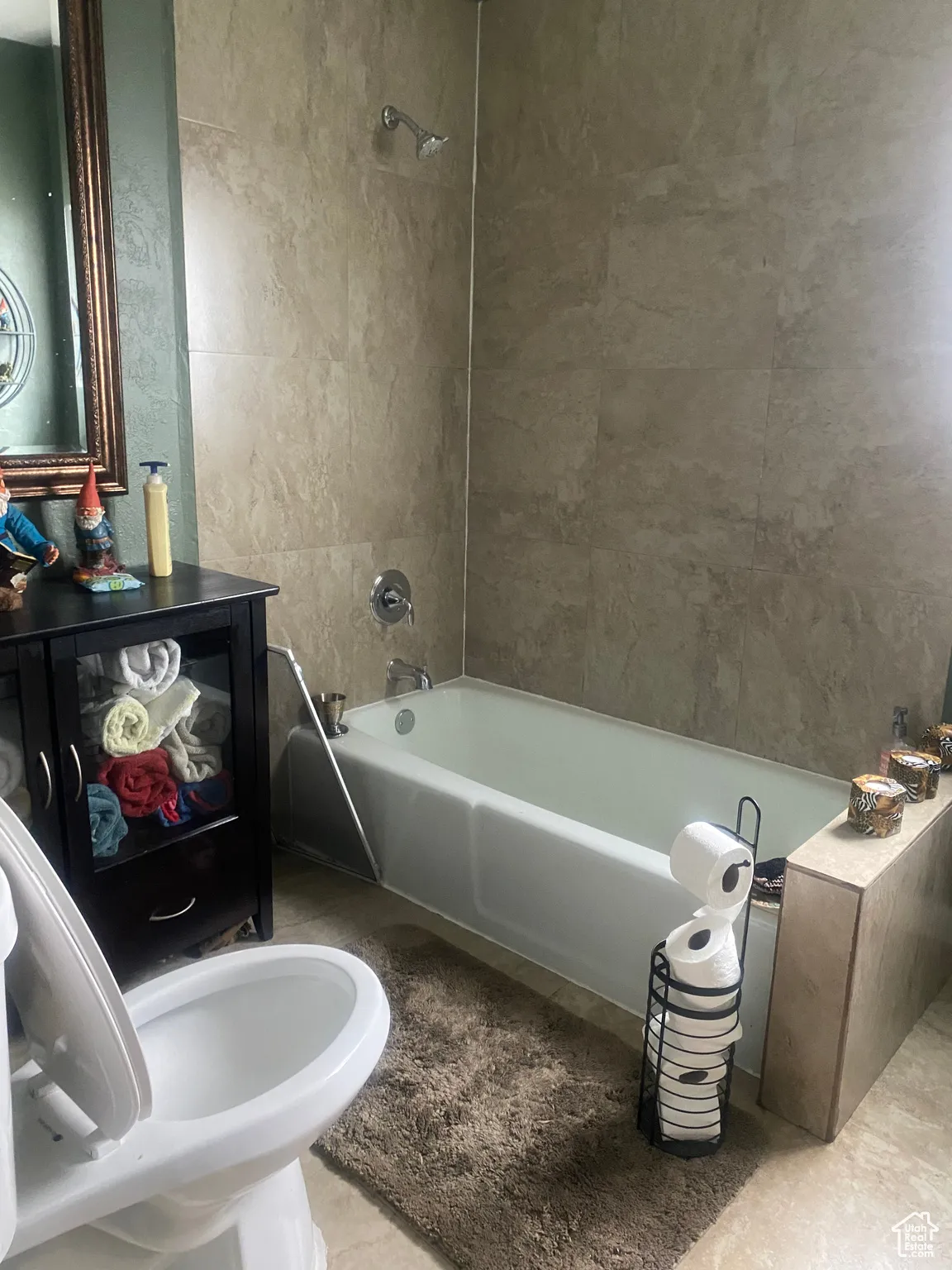 Full bath featuring tile patterned floors and shower / bath combination