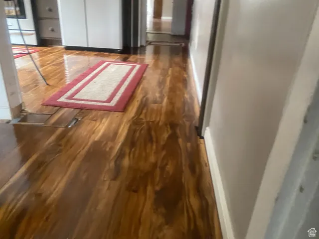 Interior space with baseboards and wood finished floors