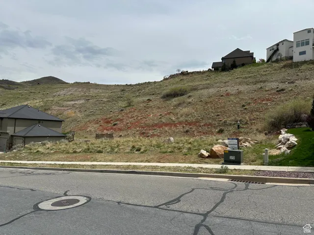 Exterior space featuring a mountain view, curbs, and sidewalks