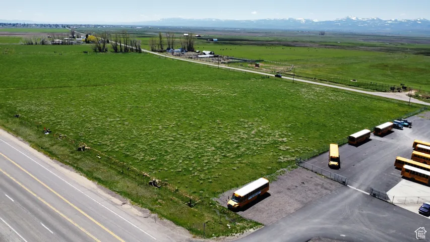 Aerial view of sparsely populated area featuring agricultural land and mountains