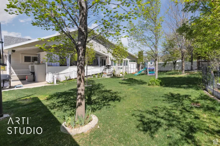 View of yard with a fenced backyard and a playground