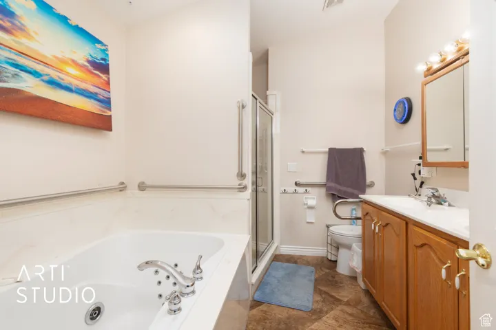 Bathroom with vanity, a jetted tub, a shower stall, and dark tile patterned flooring