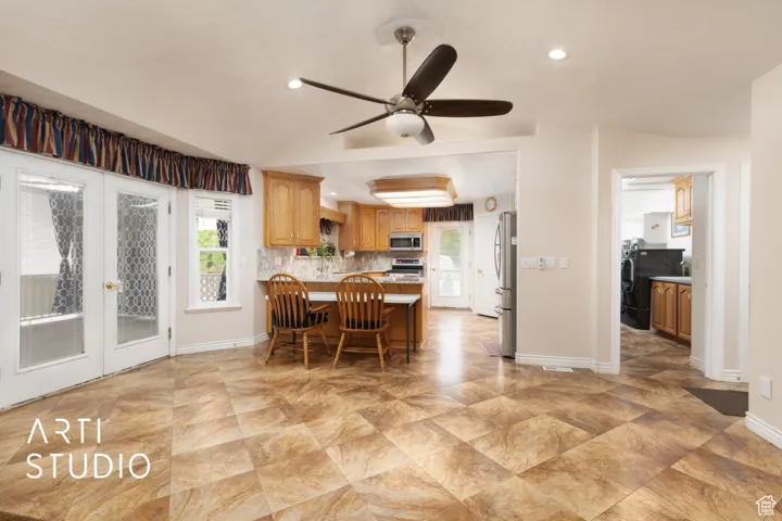 Dining space featuring plenty of natural light, french doors, lofted ceiling, a ceiling fan, and recessed lighting