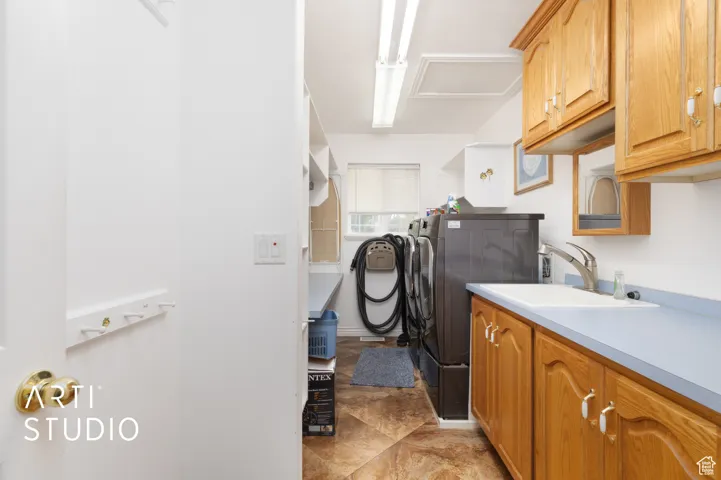 Laundry area featuring washer and dryer and cabinet space
