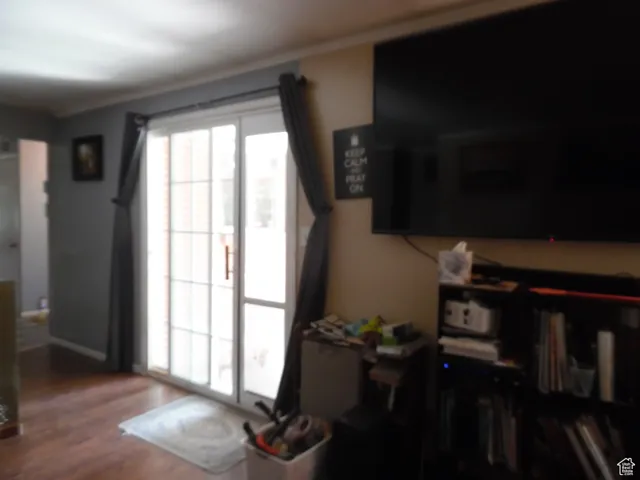 Entryway with wood finished floors and baseboards