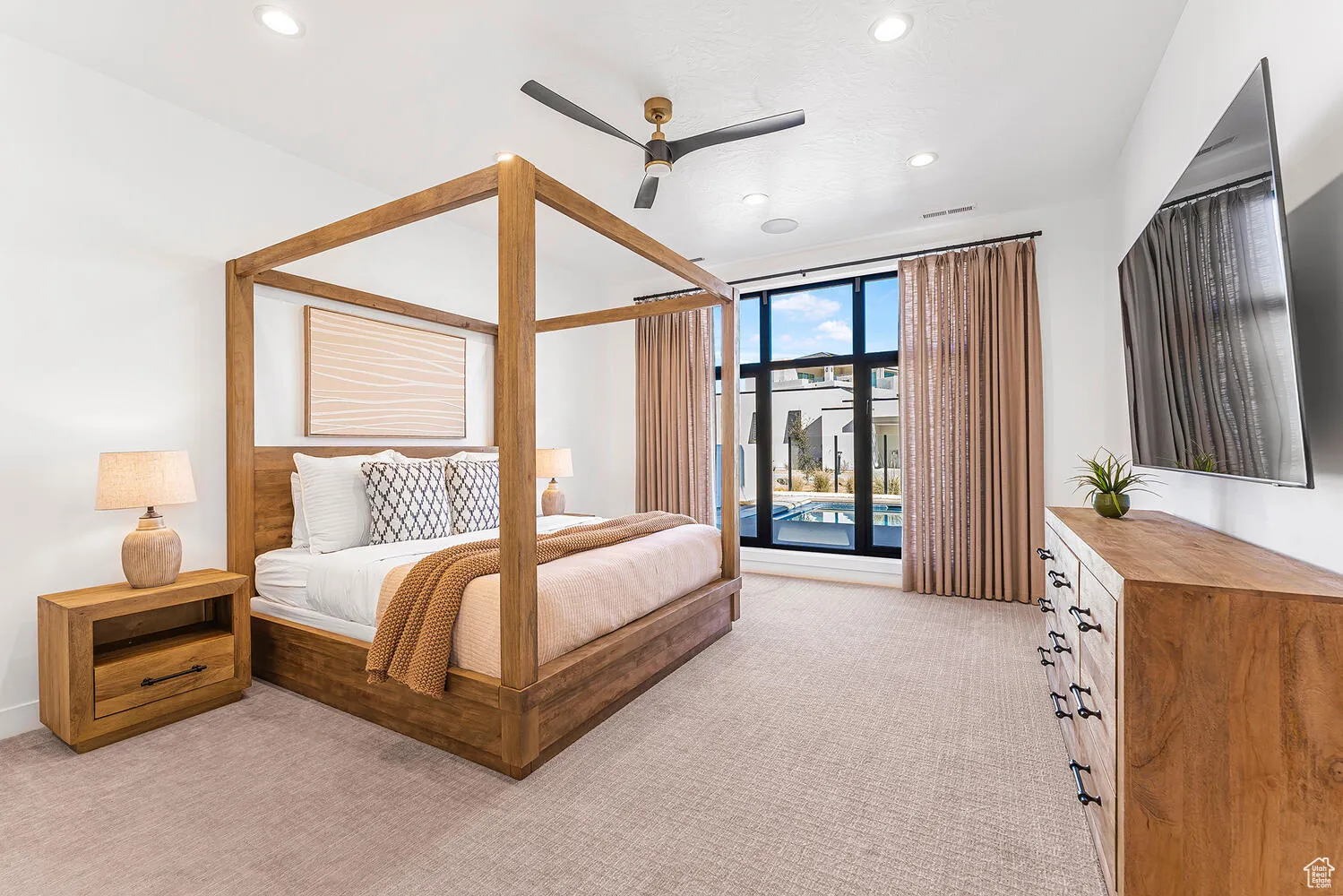 Bedroom featuring light carpet, recessed lighting, access to outside, a wall of windows, and a ceiling fan
