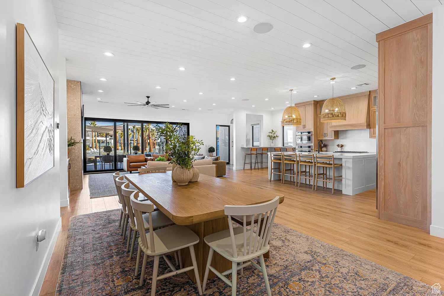 Dining area featuring light wood-type flooring, recessed lighting, wood ceiling, a ceiling fan, and baseboards