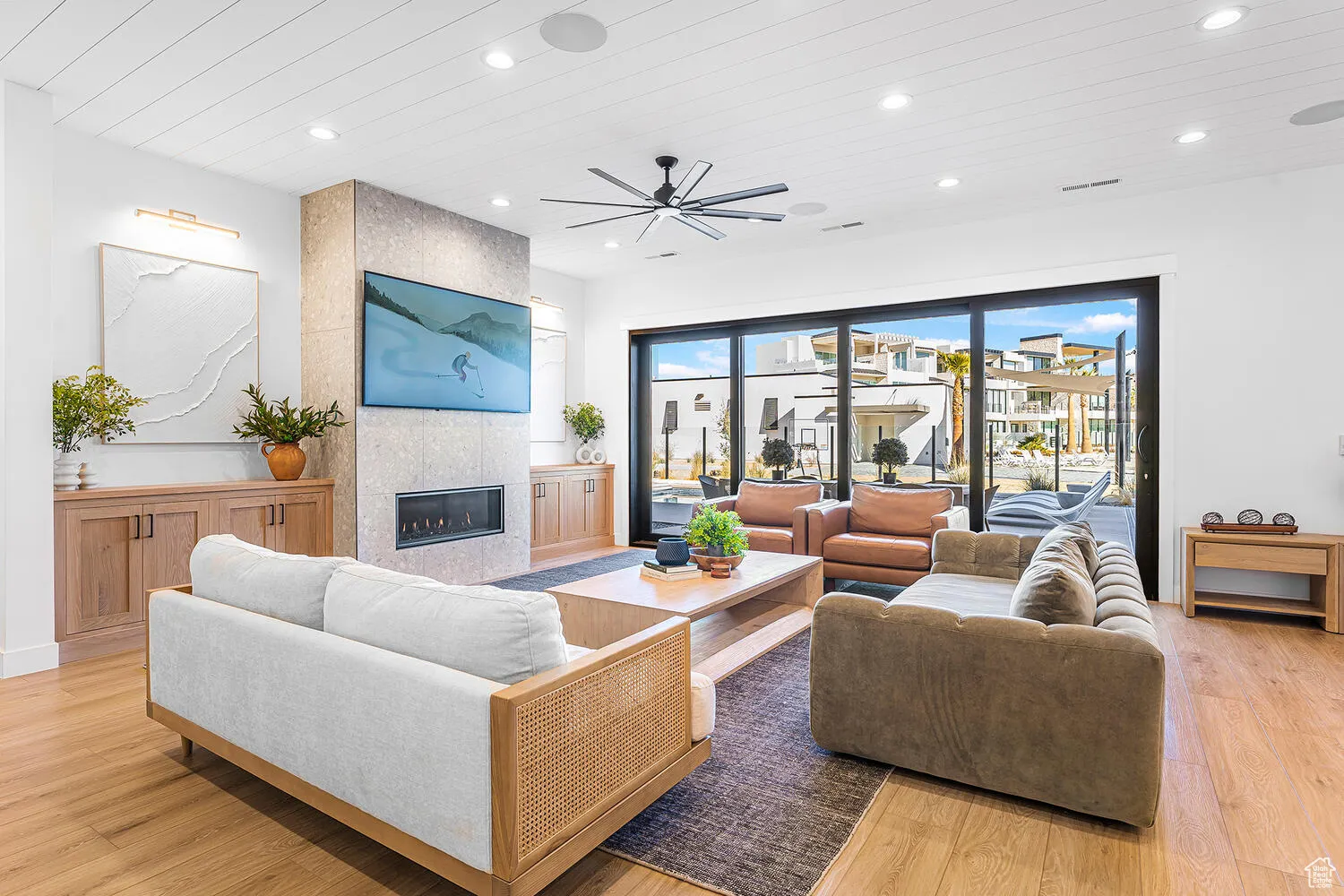 Living area featuring wooden ceiling, recessed lighting, a ceiling fan, light wood-style flooring, and a tiled fireplace
