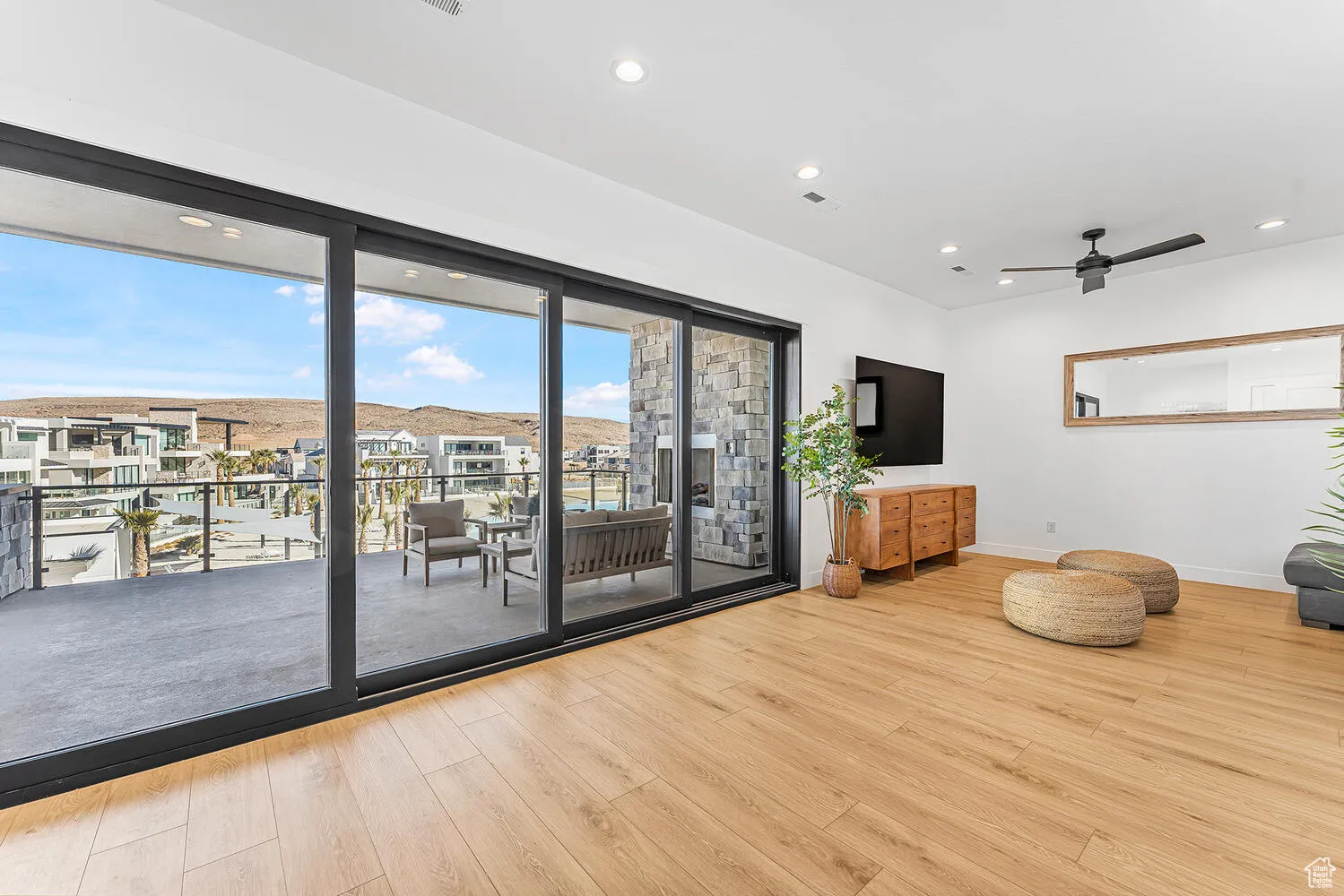 Living room featuring wood finished floors, baseboards, recessed lighting, and ceiling fan