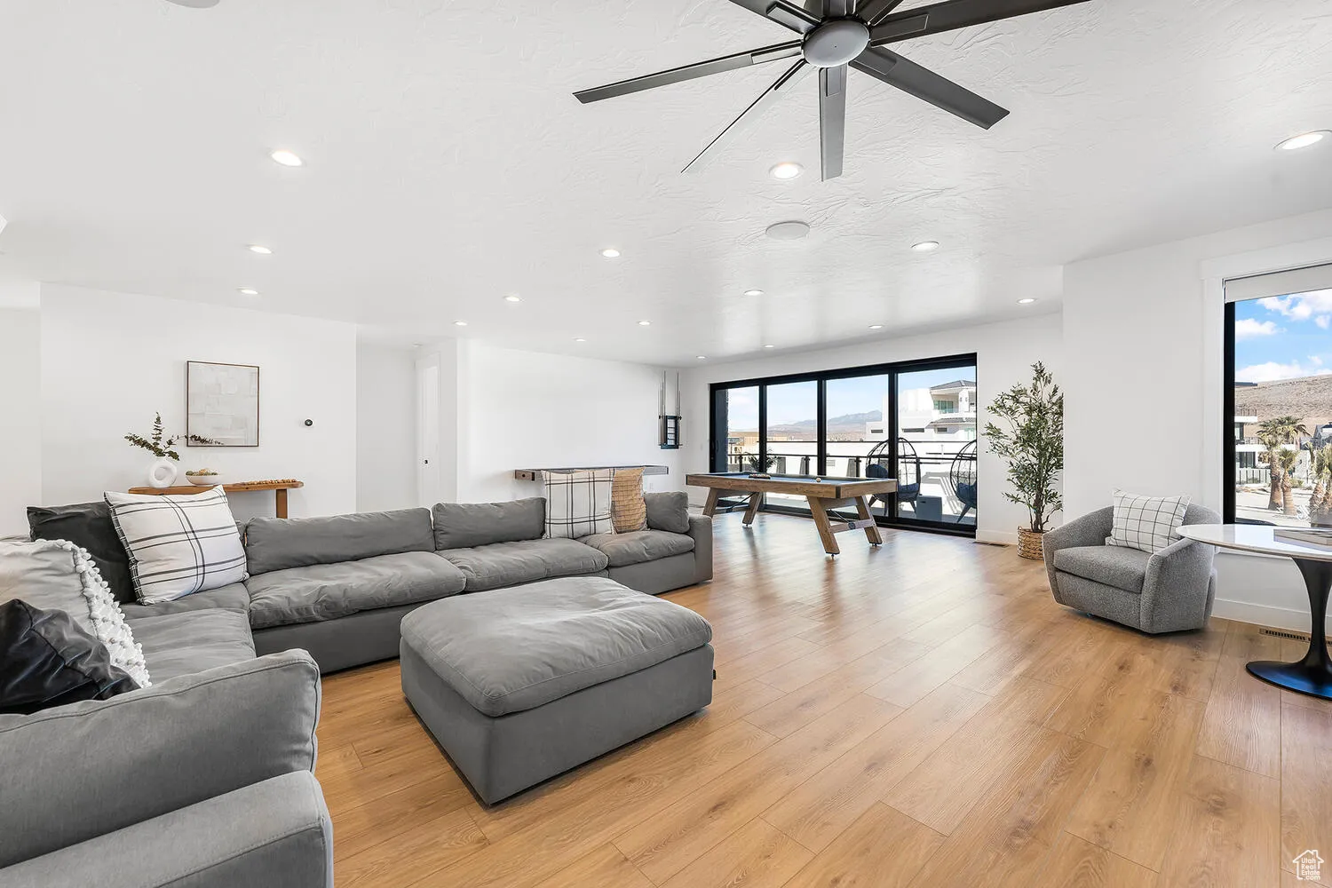 Living room featuring recessed lighting, ceiling fan, light wood-style floors, and billiards table