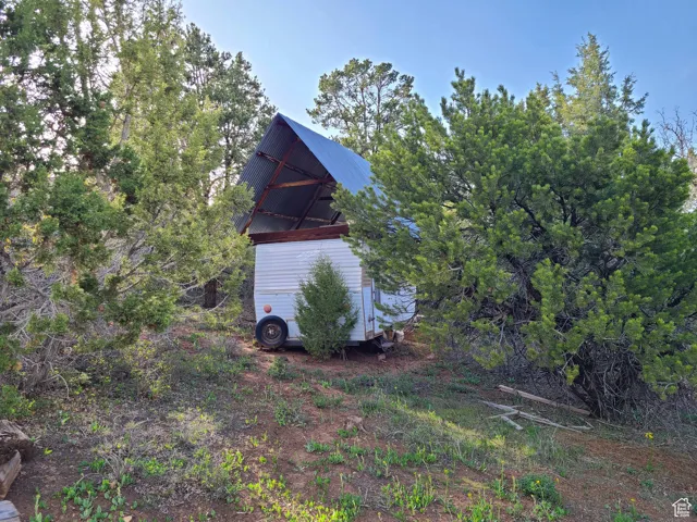 View of side of property with an outbuilding and metal roof
