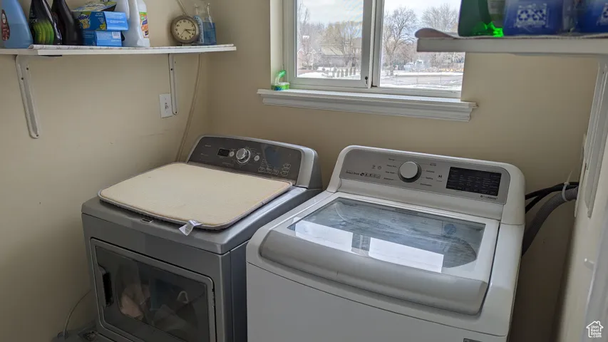 Laundry room featuring laundry area and washer and clothes dryer