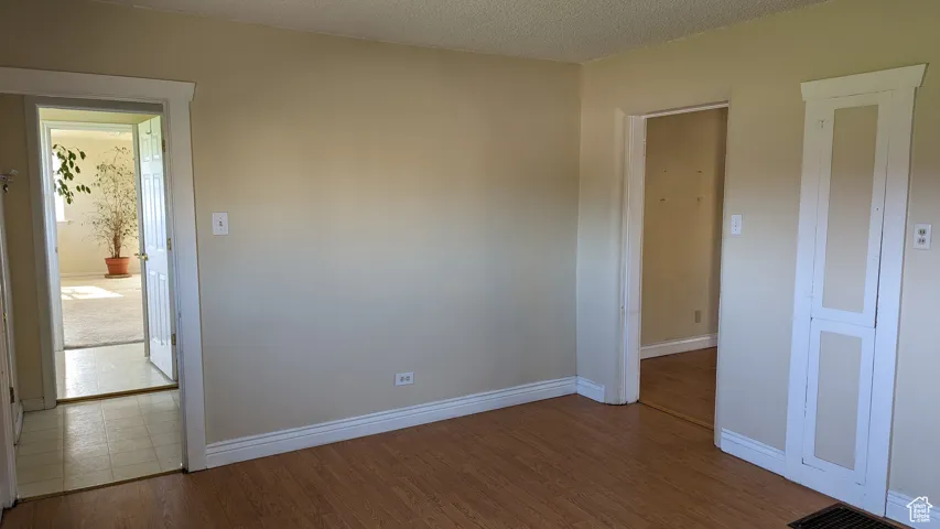 Unfurnished room featuring baseboards and wood finished floors